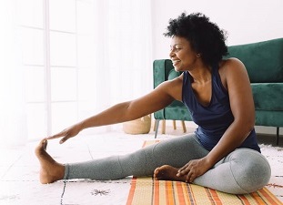 A woman doing yoga stretches at home